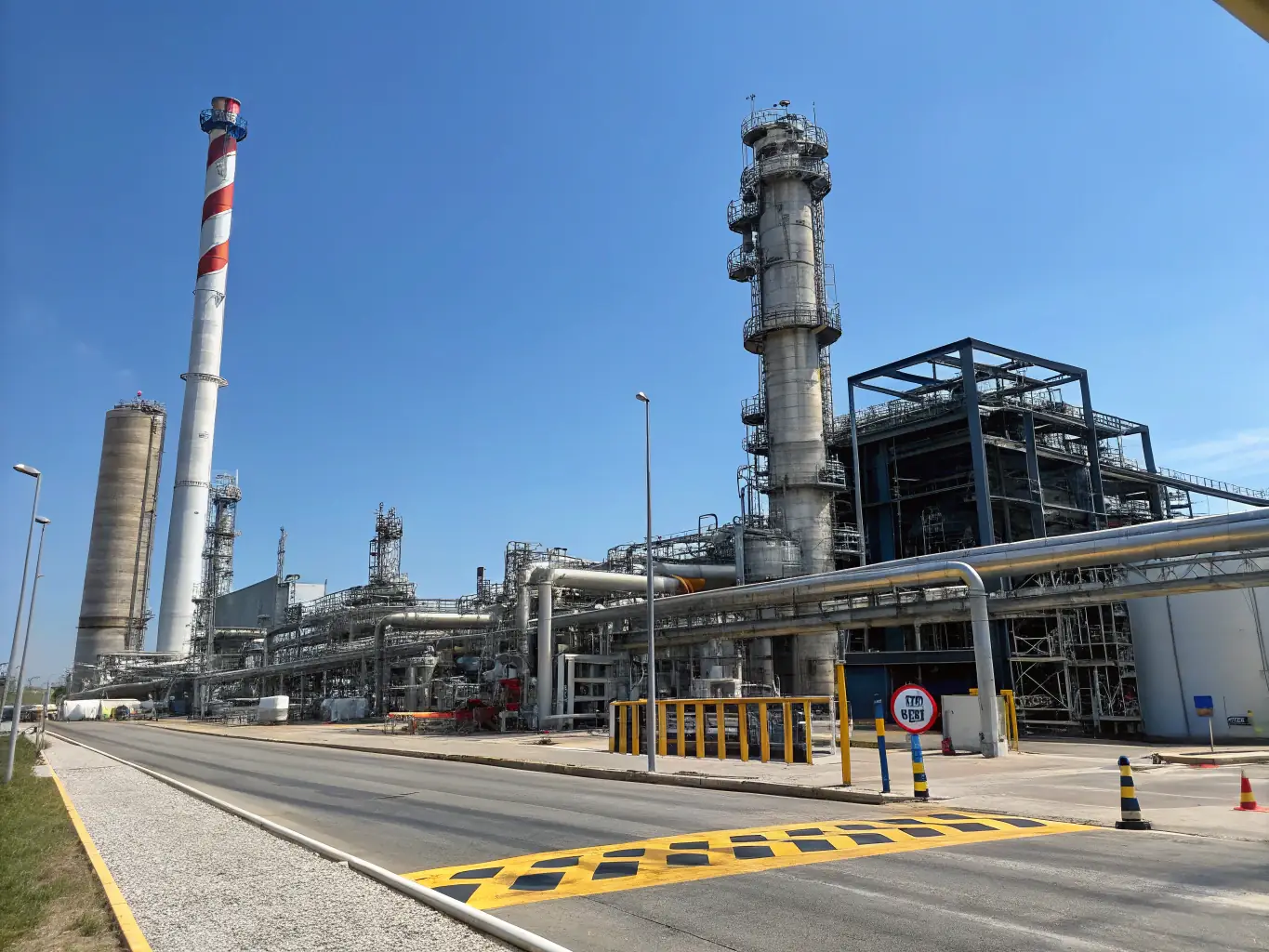 A chemical plant with storage tanks and pipelines, emphasizing the need for stringent security measures to prevent accidents and unauthorized access.