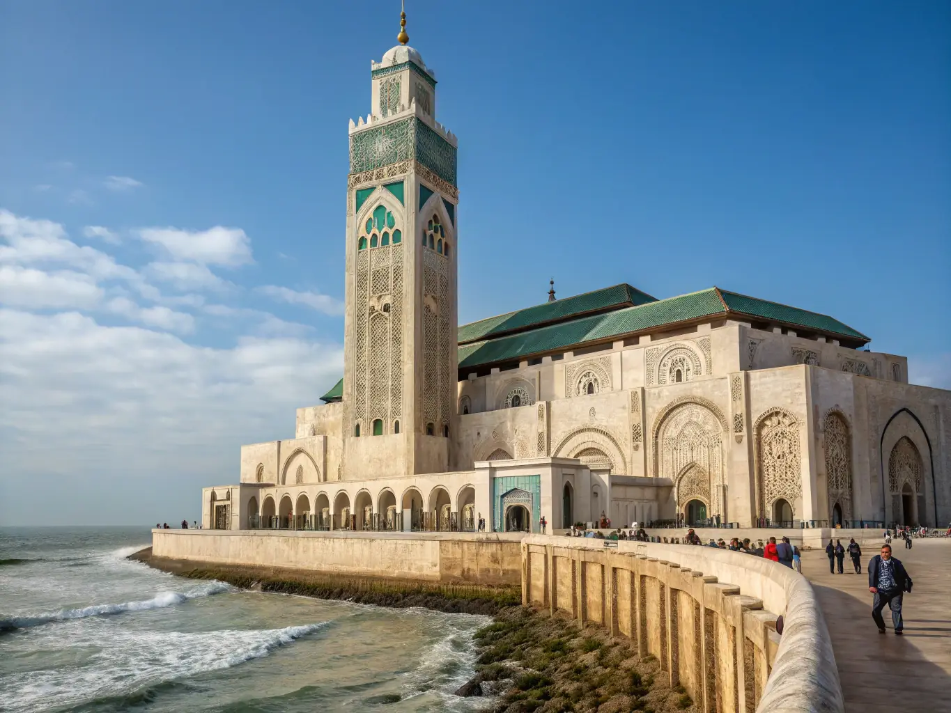 A panoramic view of the Hassan II Mosque in Casablanca, showcasing its intricate architecture and oceanfront location.