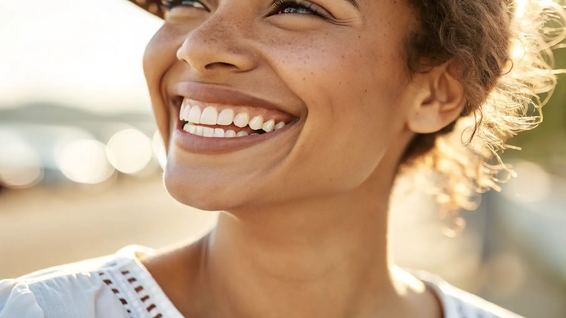 A person smiling with perfectly aligned teeth, showcasing the result of orthodontic treatment.
