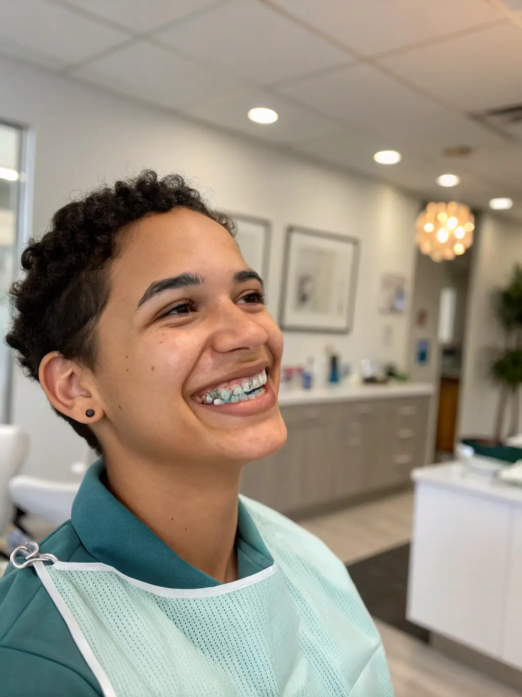 A patient smiling confidently with ceramic braces, which blend in with the natural tooth color. The image should emphasize the aesthetic appeal.