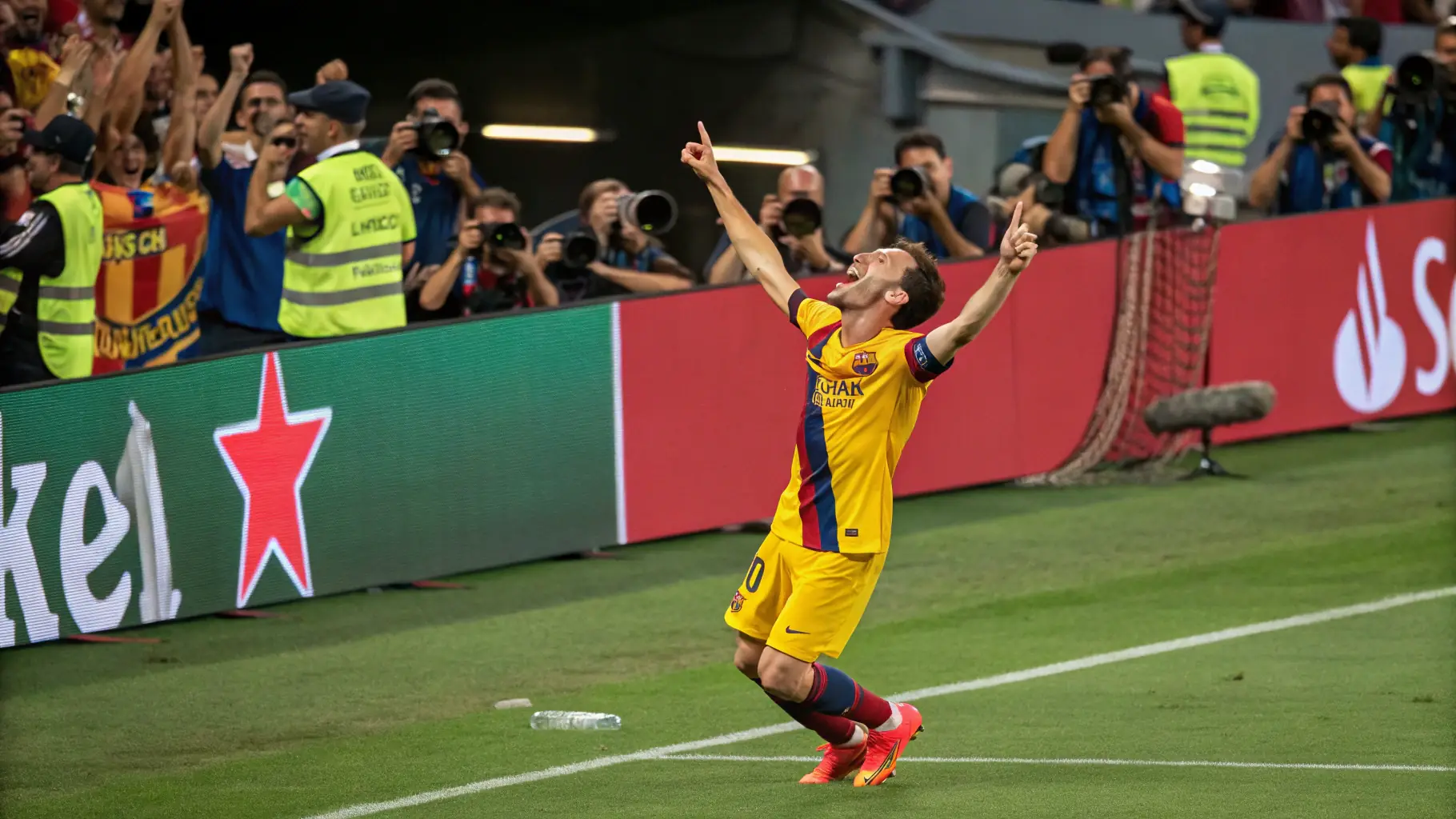 A group of young soccer players in uniform celebrating a goal during a sunny game.