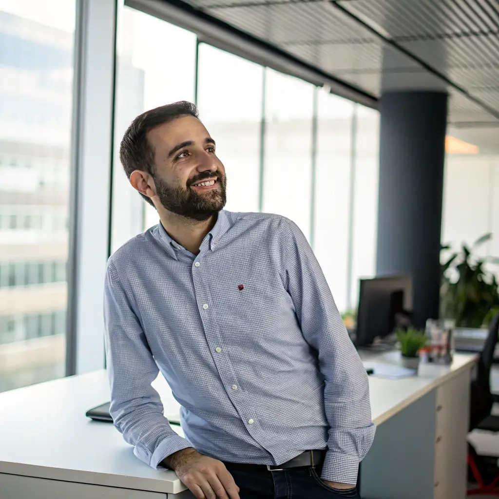 Bob is a man with a neatly trimmed beard and a friendly smile, wearing a button-down shirt.