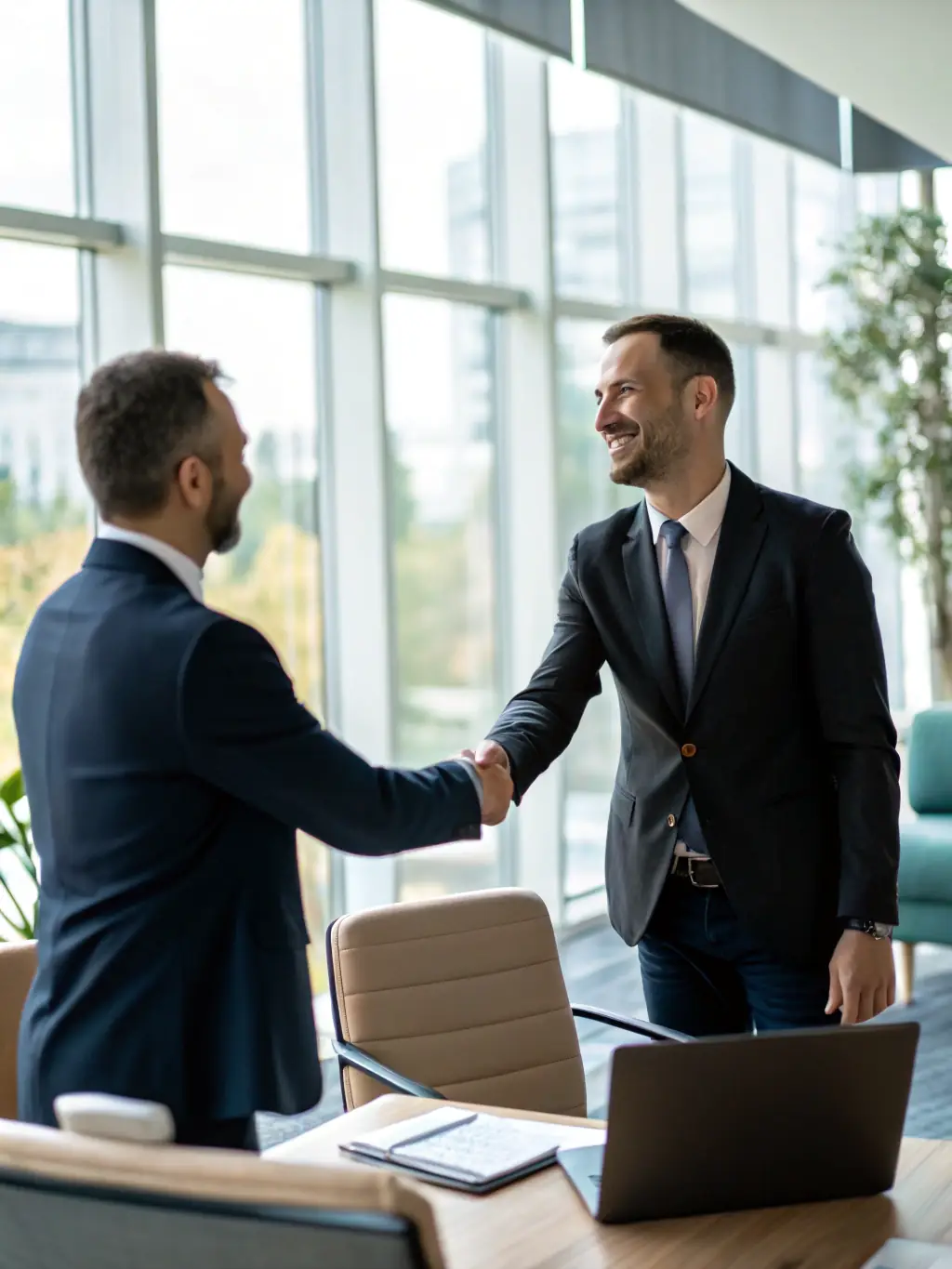 A professional shaking hands with a client at Fingerscan Digital, a CAA, symbolizing Trustpoint's coordination with acceptance agents.