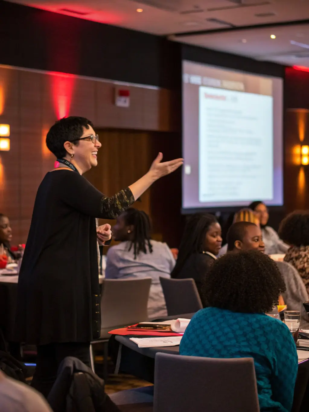 A trainer leading a staff training session on ADA compliance, with employees actively participating and learning.