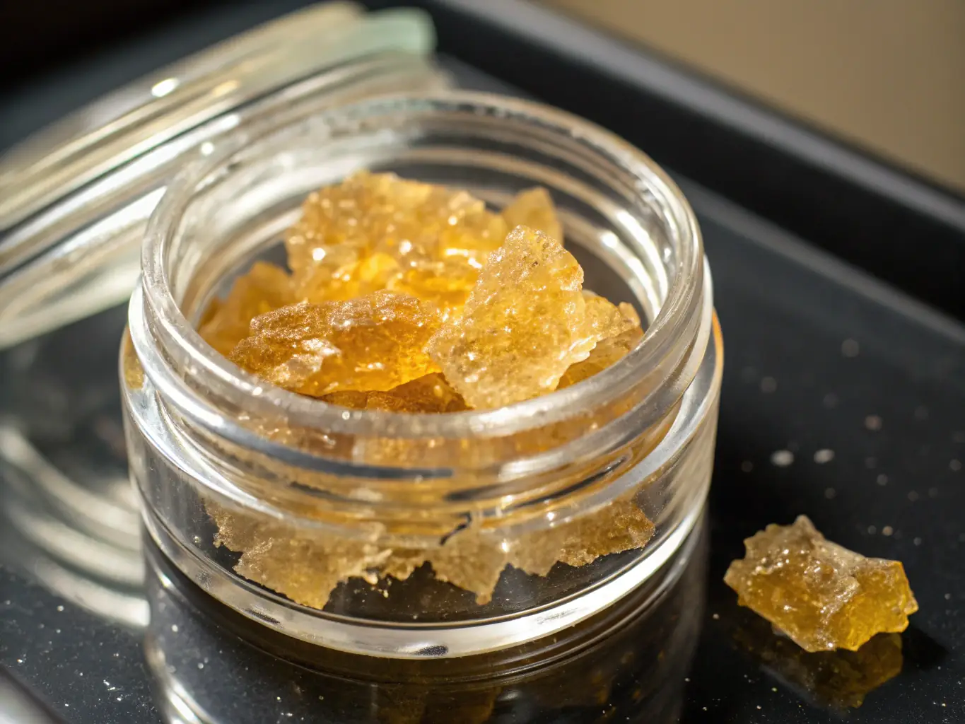 A close-up shot of various cannabis concentrates, including live resin, wax, and shatter, showcasing their textures and colors.