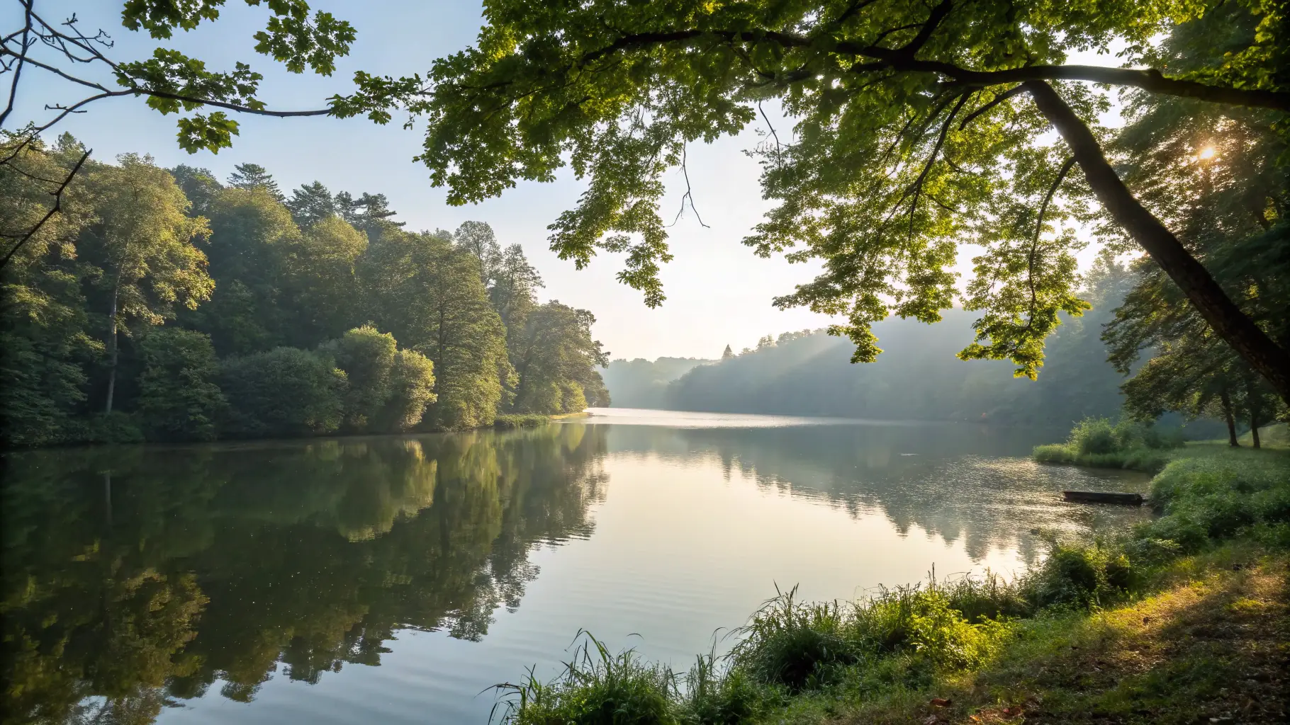 A serene image of a peaceful landscape, such as a calm lake or a quiet forest, symbolizing healing and emotional recovery. The image should evoke a sense of tranquility and hope, reflecting the supportive environment offered by Gwen Gould Therapy for grief recovery.