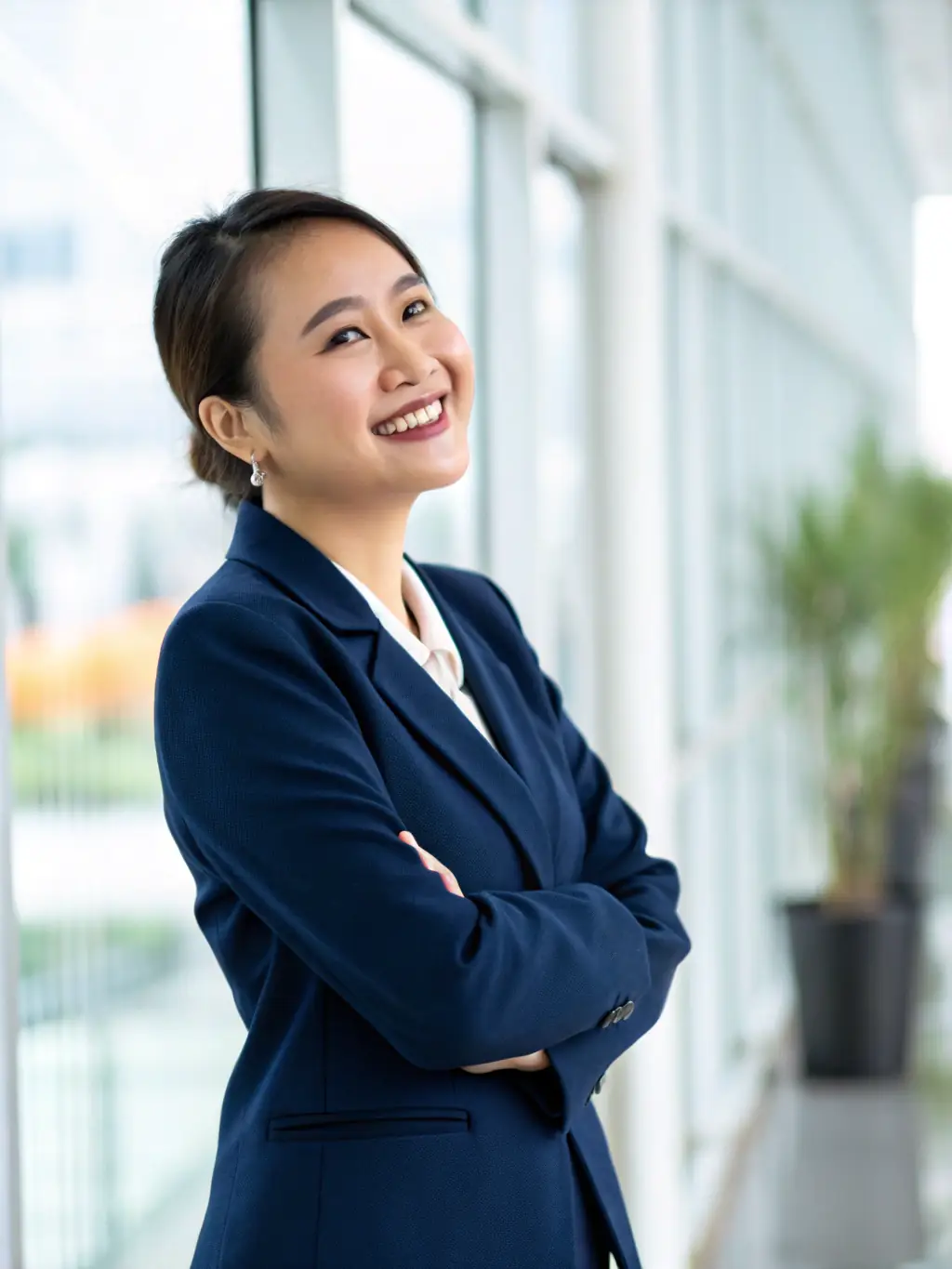 A friendly Vietnamese-speaking paralegal assisting a client with their Social Security disability application in a bright, modern office setting. The paralegal is explaining a document with a reassuring smile.