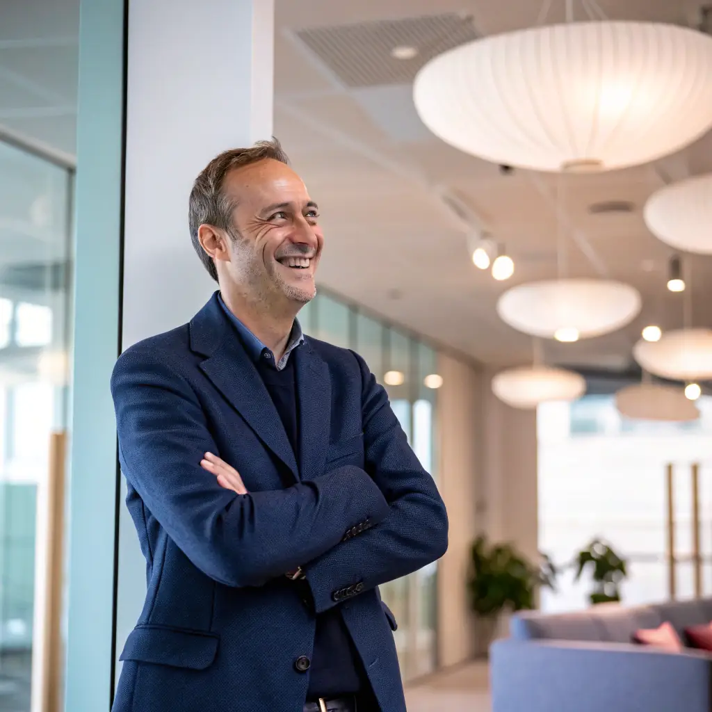 a professional headshot of the founder, warm lighting, in a business casual setting, high-resolution, suitable for website use