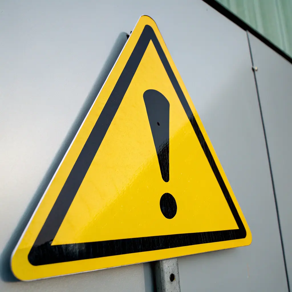 an illustrative warning icon with a bold, red warning triangle and exclamation mark, symbolizing security alert and caution