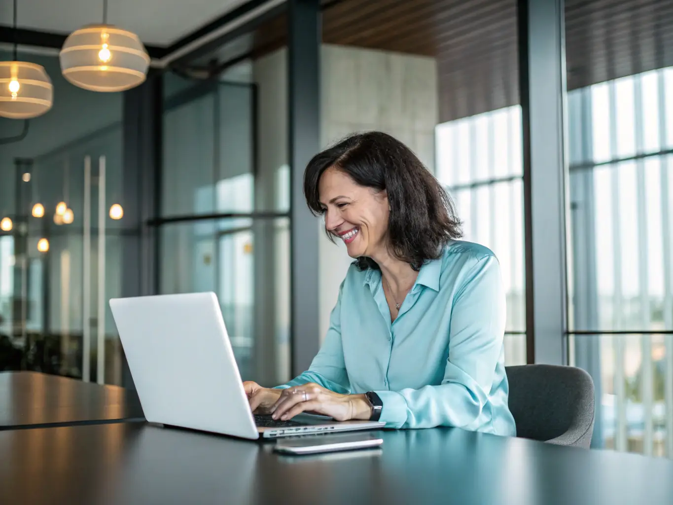 A professional, confident individual holding a laptop, symbolizing career success and readiness to take on new opportunities