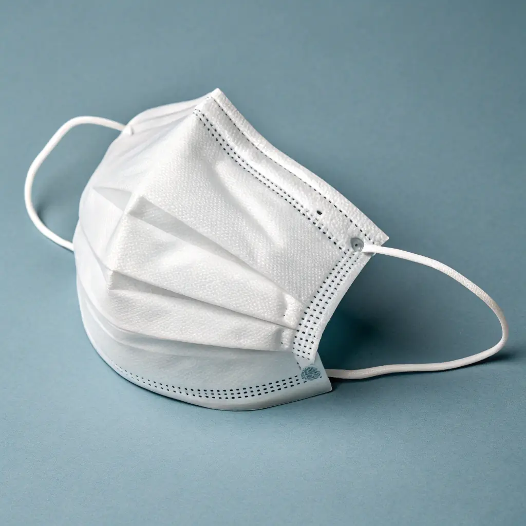 A close-up shot of a Brava Maske being tested in a laboratory setting, showcasing its multi-layered construction and filtration capabilities. The image should convey a sense of scientific rigor and reliability.