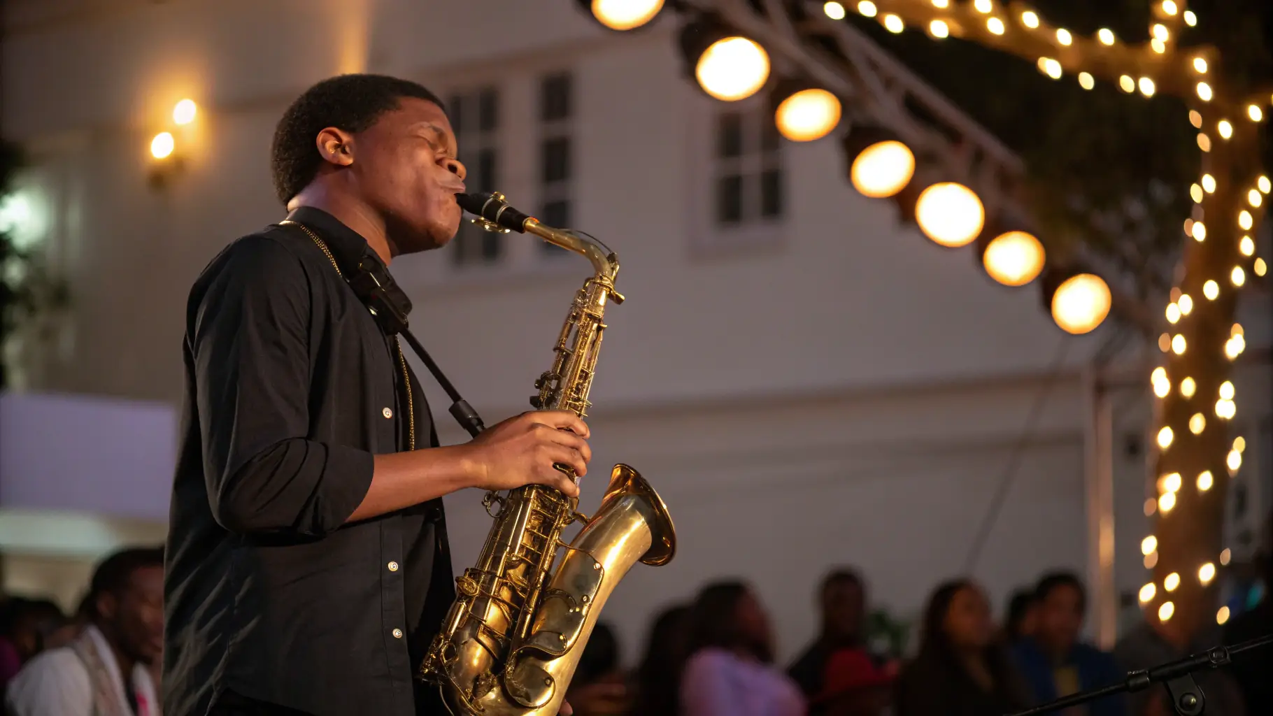 A professional musician playing a musical instrument on stage during a concert.