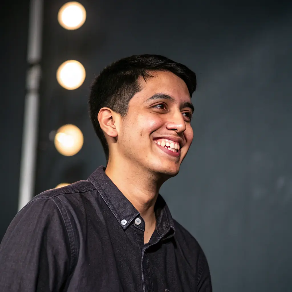 David is a young man with short black hair and a friendly, determined expression. He wears a casual button-down shirt.
