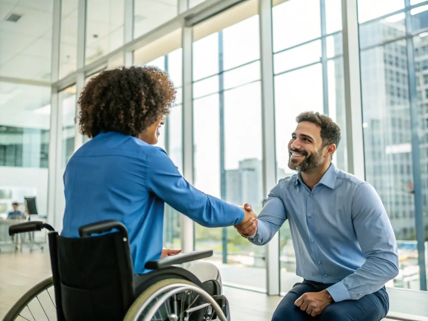 A person in a wheelchair receiving assistance with paperwork from a legal professional.
