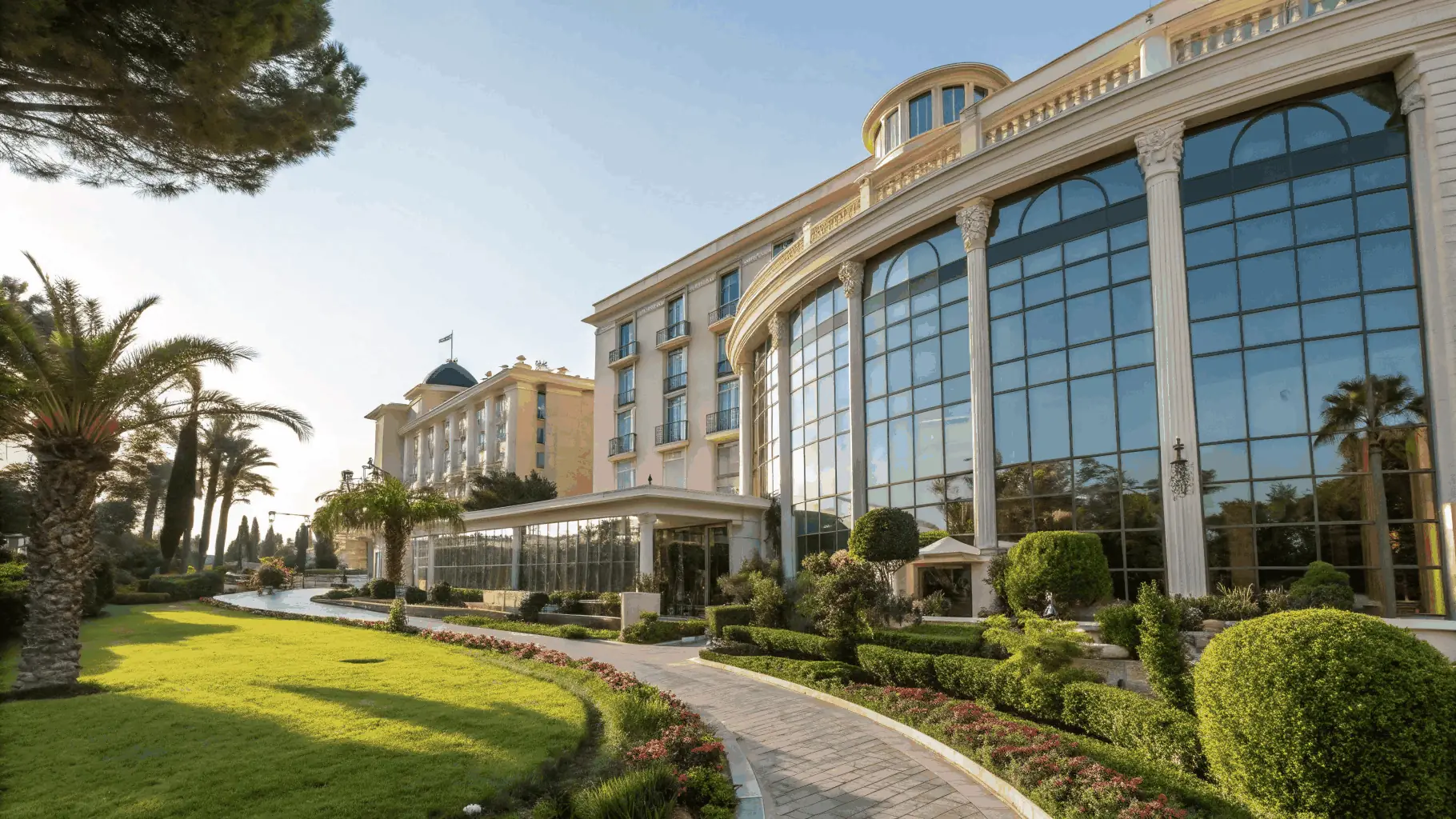 A panoramic view of the Lermonteno hotel facade showcasing its elegant architecture and lush surroundings.