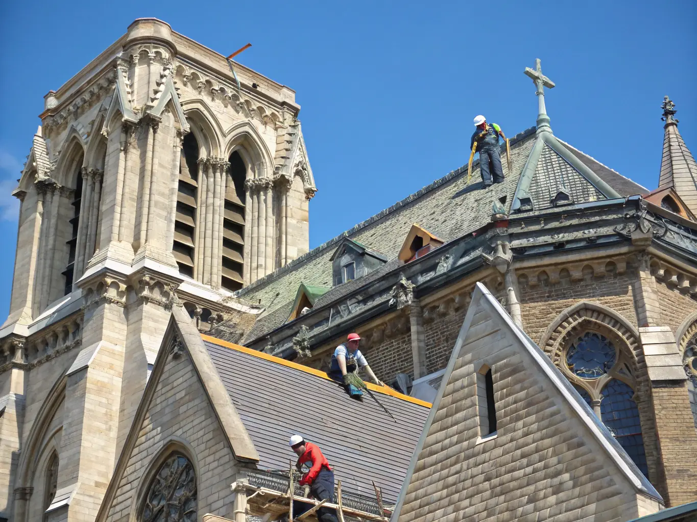 A vibrant image of the Saint-Hilaire Church during restoration, capturing the historical architecture and community involvement.