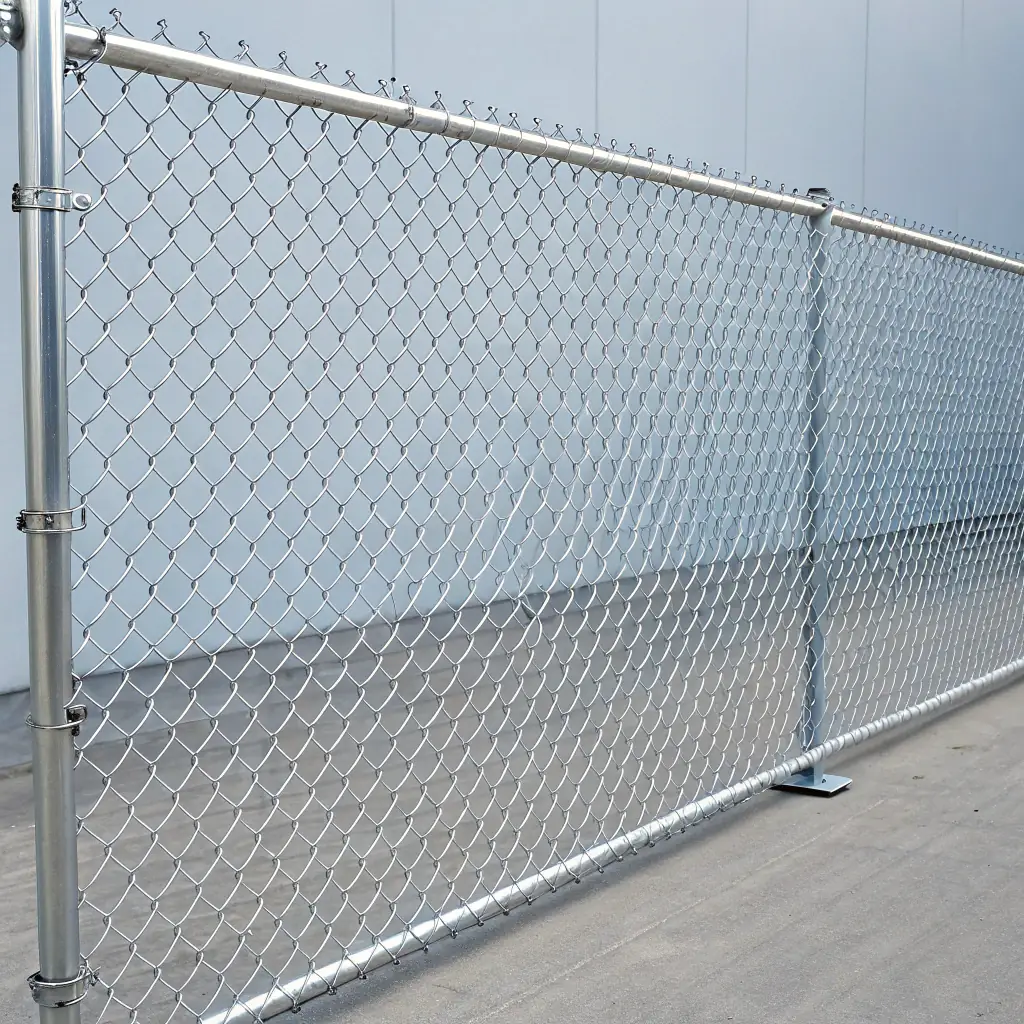 A high-angle close-up shot of a newly manufactured chain link fence with a focus on the precise welding and uniform mesh pattern, set against a blurred industrial backdrop.