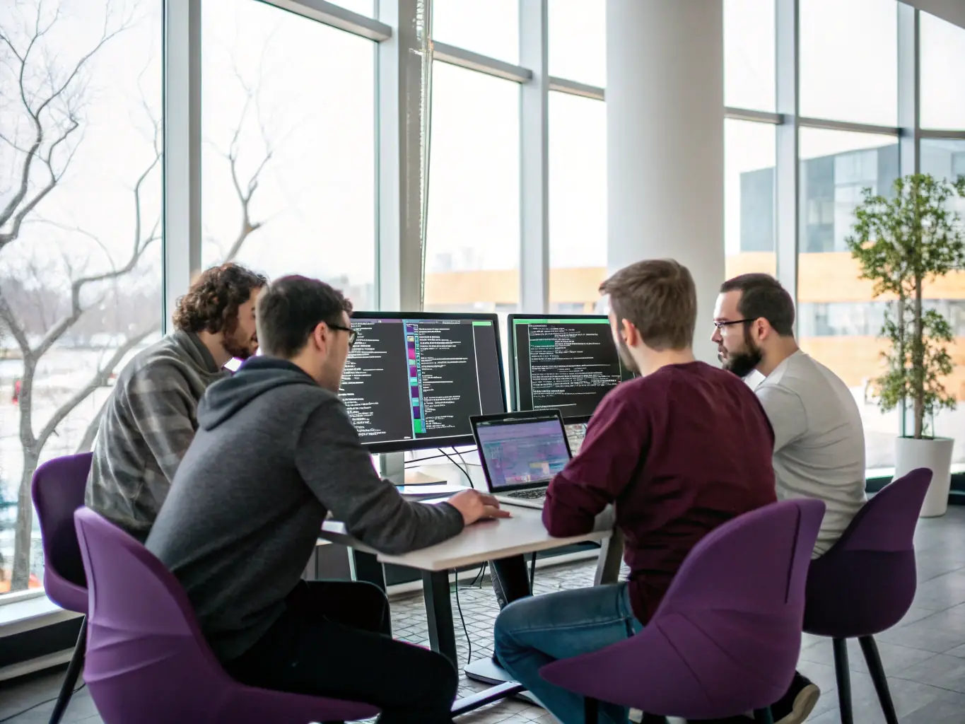 A team of developers working on a computer, showcasing the development process for a POC/MVP.