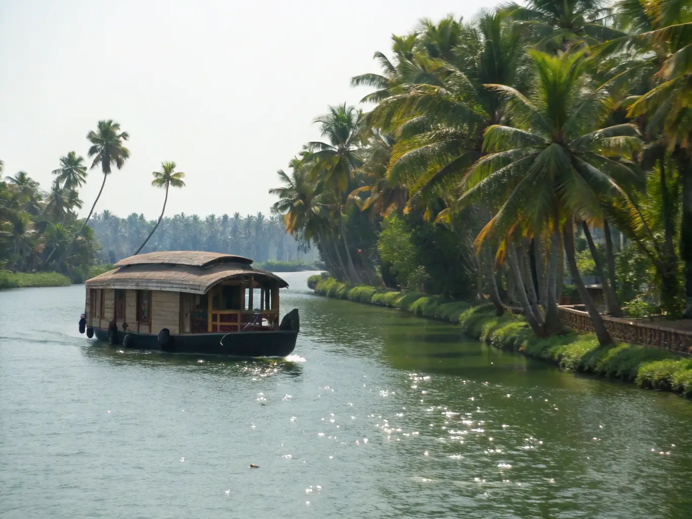 Scenic view of Alleppey houseboat route with lush green banks and clear water.
