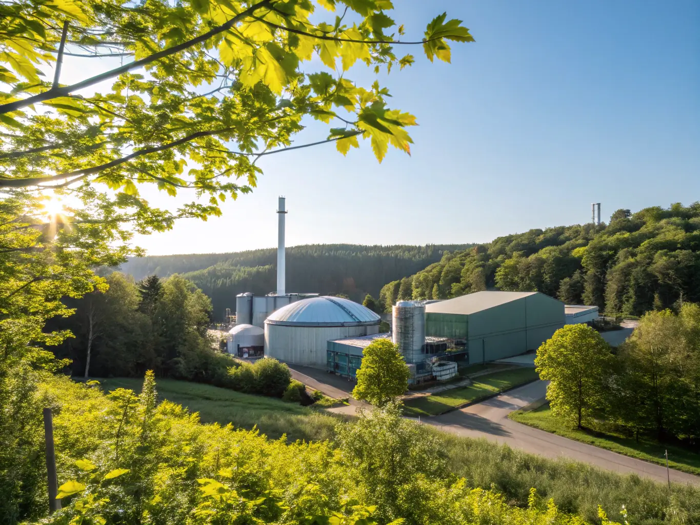 A biofuel plus factory with a green field in the background.